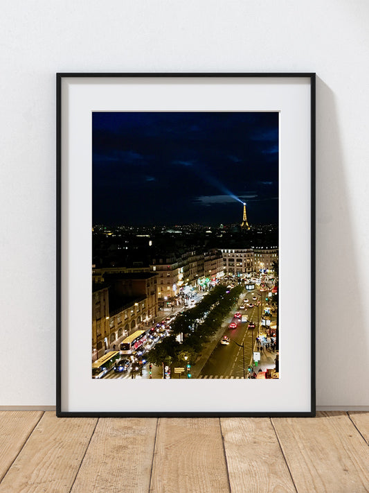 A photograph of the Eiffel Tower at night