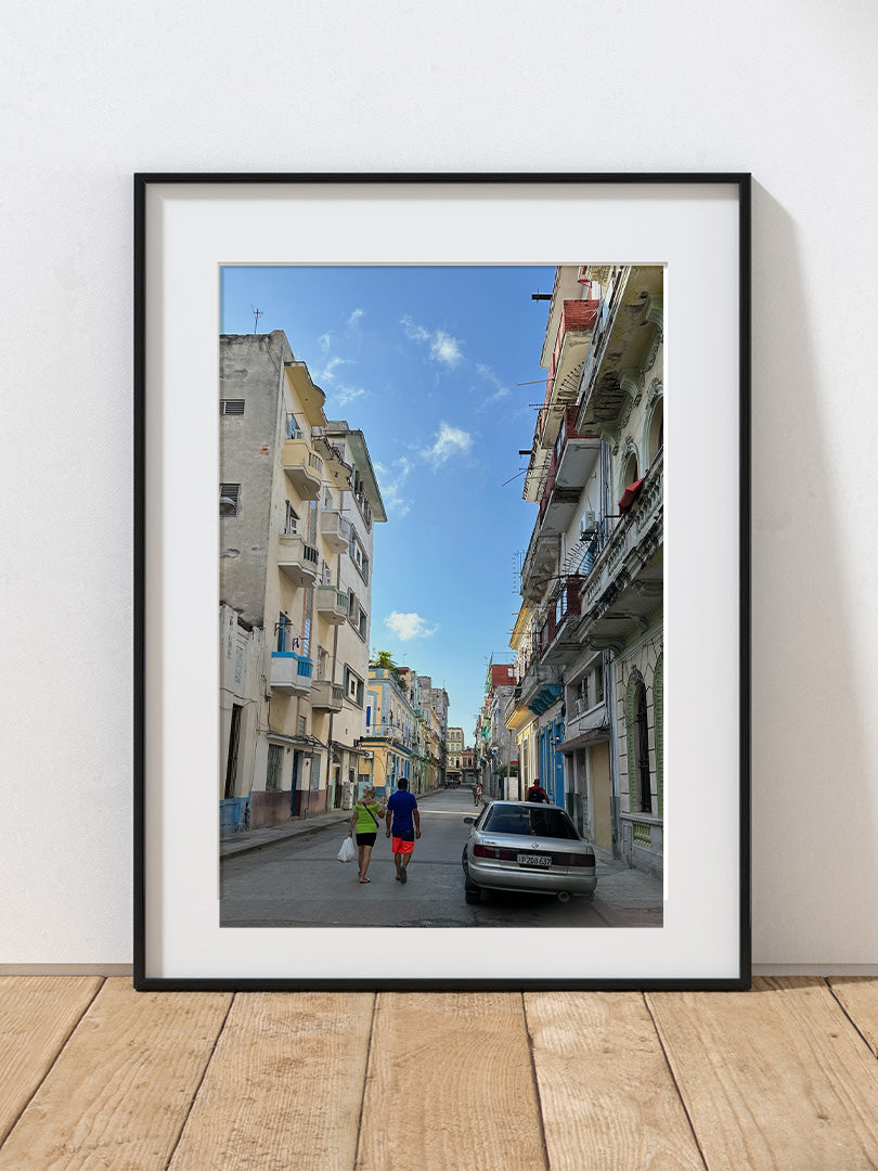 A photograph of a street scene with people walking in Havana, Cuba